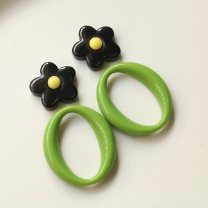 DIY colorful geometric acrylic flower earrings with green oval hoops and floral studs