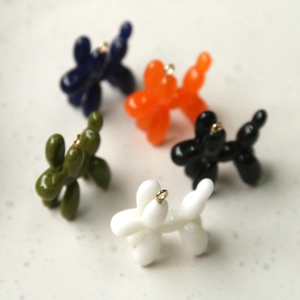 Detailed view of colorful resin balloon dog charms with golden loops for DIY jewelry making
