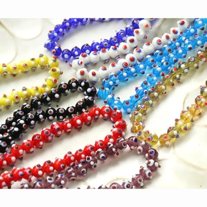 Detailed macro view of colorful lampwork glass beads with funny eye patterns for DIY crafts