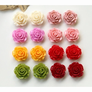 Flat lay of colorful 3D resin rose cabochons for DIY jewelry and phone case decoration