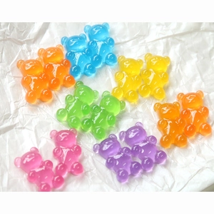 Detailed macro view of colorful translucent jelly resin bear charms for DIY crafting