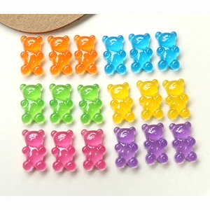 Flat lay of colorful gummy bear resin charms for DIY jewelry and phone case making
