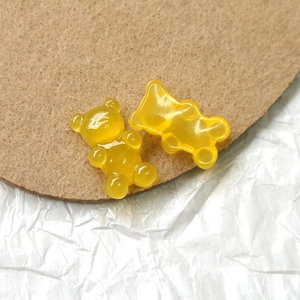 Macro detail of glossy yellow resin bear charms with a translucent jelly finish