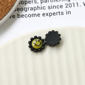 Macro shot of colorful acrylic sunflower charms with smiley faces for DIY accessories