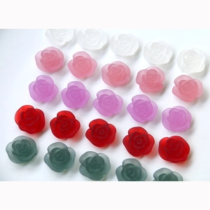 Macro detail of matte resin rose beads in various colors for DIY craft jewelry making