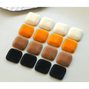 Vue macro de 16 boutons carrés en velours floqué aux tons chauds pour travaux DIY