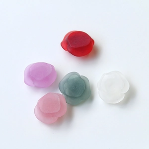 Macro detail of DIY resin rose charms in five colors with a frosted matte finish for jewelry