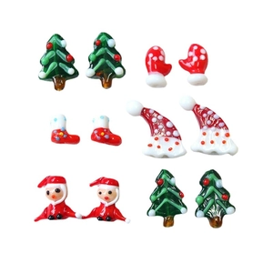 Handmade lampwork glass Christmas charms featuring Santa hats, trees, and socks for DIY crafts