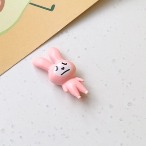 Macro shot of 3D pink rabbit resin charm with unique expression for DIY crafts