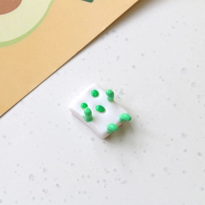 Detail view of 3D panda rabbit mahjong doll resin cabochon with green dot pattern