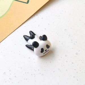 Macro view of a 3D miniature panda figurine in lying posture for DIY craft accessories