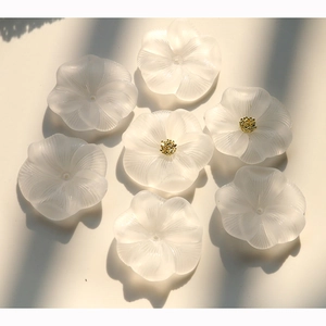 Detailed macro view of frosted white acrylic lotus flower DIY jewelry accessories