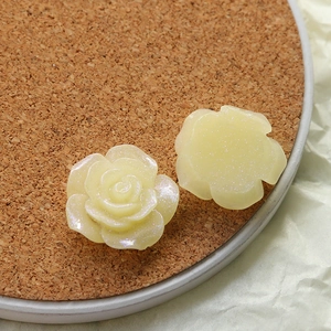Macro detail of pearlescent cream resin roses for DIY jewelry and phone case crafts