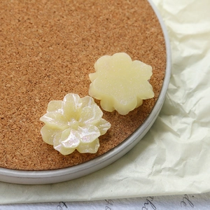 Macro detail of iridescent yellow resin rose petals for DIY craft and jewelry making