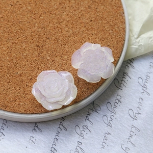 Macro view of pearlescent pink resin rose with glitter for DIY jewelry and hair accessories
