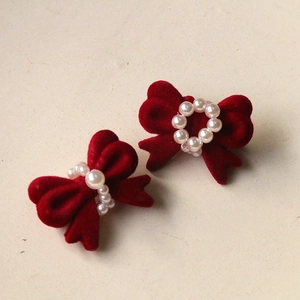 Close-up of wine red flocked bow accessories with faux pearls for DIY jewelry making