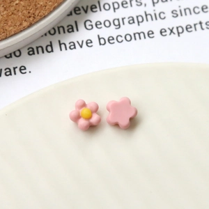 Detailed close-up of matte pink acrylic sunflower DIY accessories on a ceramic plate
