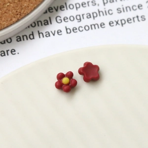 Macro shot of red floral resin nail art charms and DIY jewelry accessories
