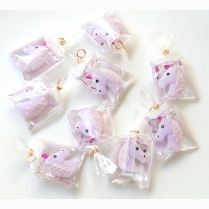 Pastel purple unicorn resin charms in transparent bags with gold rings for DIY jewelry making