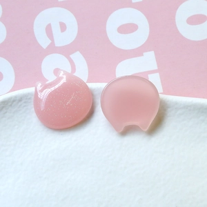 Macro detail of glitter pink resin cat charms for DIY crafts and hair accessories