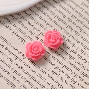 Detailed macro shot of peach pink flocked rose acrylic accessories for DIY jewelry making