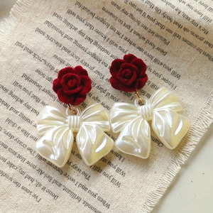 Elegant red flocked rose earrings with pearl white bow charm and golden hardware