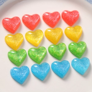 Detailed grid of 16 colorful glitter resin hearts for DIY jewelry and hair accessories