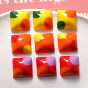 Detailed view of colorful polka dot resin square charms for DIY jewelry and crafts