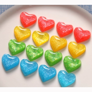 Macro shot of colorful glittery resin hearts for DIY jewelry and phone case crafts