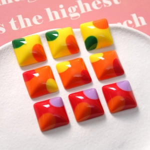 Macro shot of colorful polka dot resin square charms for DIY jewelry and hair accessories
