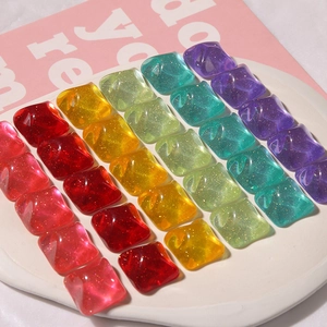 Macro shot of 24 colorful square resin charms with glitter and water ripple texture