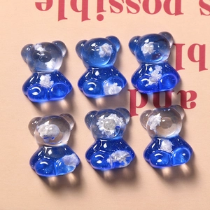 Detailed view of six resin bear charms with blue starlight gradient and cloud patterns