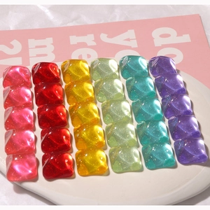 Macro view of square resin glitter cabochons in candy colors for DIY jewelry making