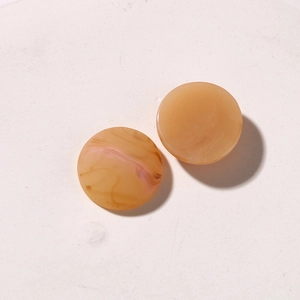 Detail of round amber resin accessories with marble texture for jewelry and DIY crafts