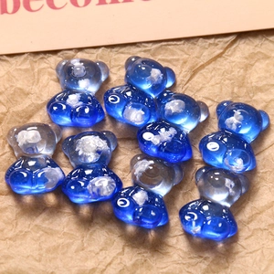 Macro detail of blue gradient resin bear charms with cloudy white inclusions for DIY