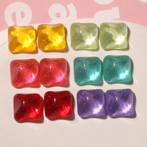 Macro detail of square resin charms with wavy texture and glitter in assorted candy colors