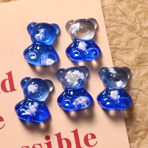 Close-up of five blue gradient resin bear charms with cloud textures for DIY crafting