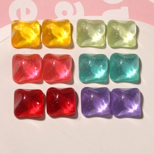 Close-up of square resin glitter cabochons in candy colors for DIY jewelry and crafts