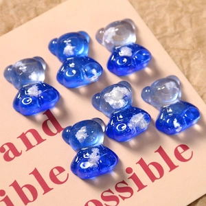 Close-up of six blue transparent resin bears with white clouds inside for DIY crafts