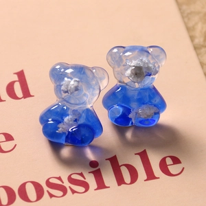 Detailed macro view of Klein blue resin bear accessories with gradient starry sky texture