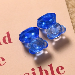 Macro view of translucent blue resin bear charms with dreamy starry sky texture