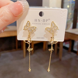 Detail of long butterfly tassel earrings with sparkling rhinestones and S925 silver pins