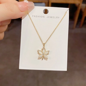 Elegant gold maple leaf pendant necklace with shell pearls and crystal accents