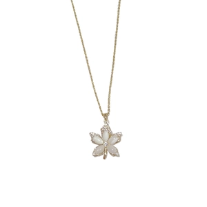 Golden necklace featuring a maple leaf shell pendant with sparkling zircon embellishments