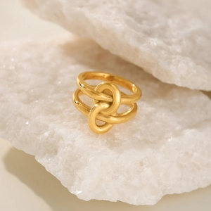 18k gold plated double layer intertwined ring on white stone background