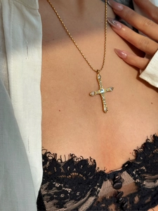 Close-up of 18k gold-plated cross necklace featuring marquise-cut crystal stones