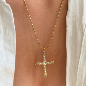 18k gold plated stainless steel cross necklace with zircon on a white linen shirt