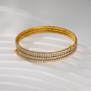 Detailed macro view of 18k gold plated multi-layer wrap bracelet with cubic zirconia