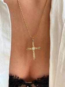 Detail view of 18k gold plated cross necklace with clear crystals on a long bead chain