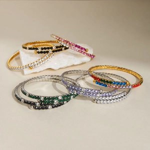 Macro detail of elastic 18k gold plated tennis bracelets with colorful crystal rhinestones